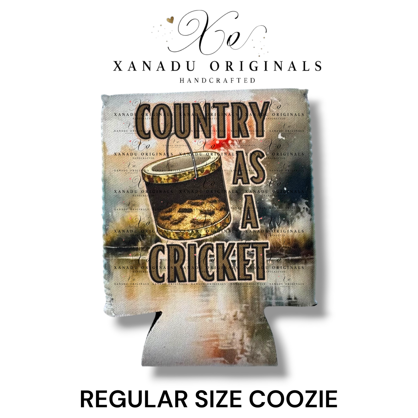 "Xanadu Originals handcrafted regular size neoprene can coozie featuring an artistic illustration of an old bucket filled with crickets with the bold rustic text 'COUNTRY AS A CRICKET' on a distressed canvas background."