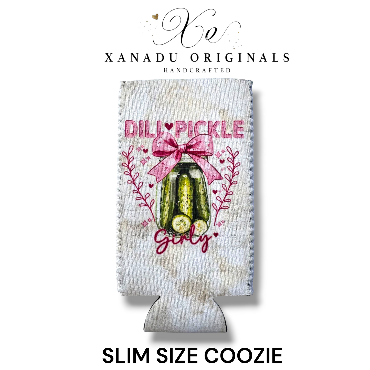 "Xanadu Originals handcrafted slim size neoprene can coozie featuring a rustic glass jar of dill pickles decorated with a large pink bow and the text 'Dill Pickle Girly' against a light textured background."