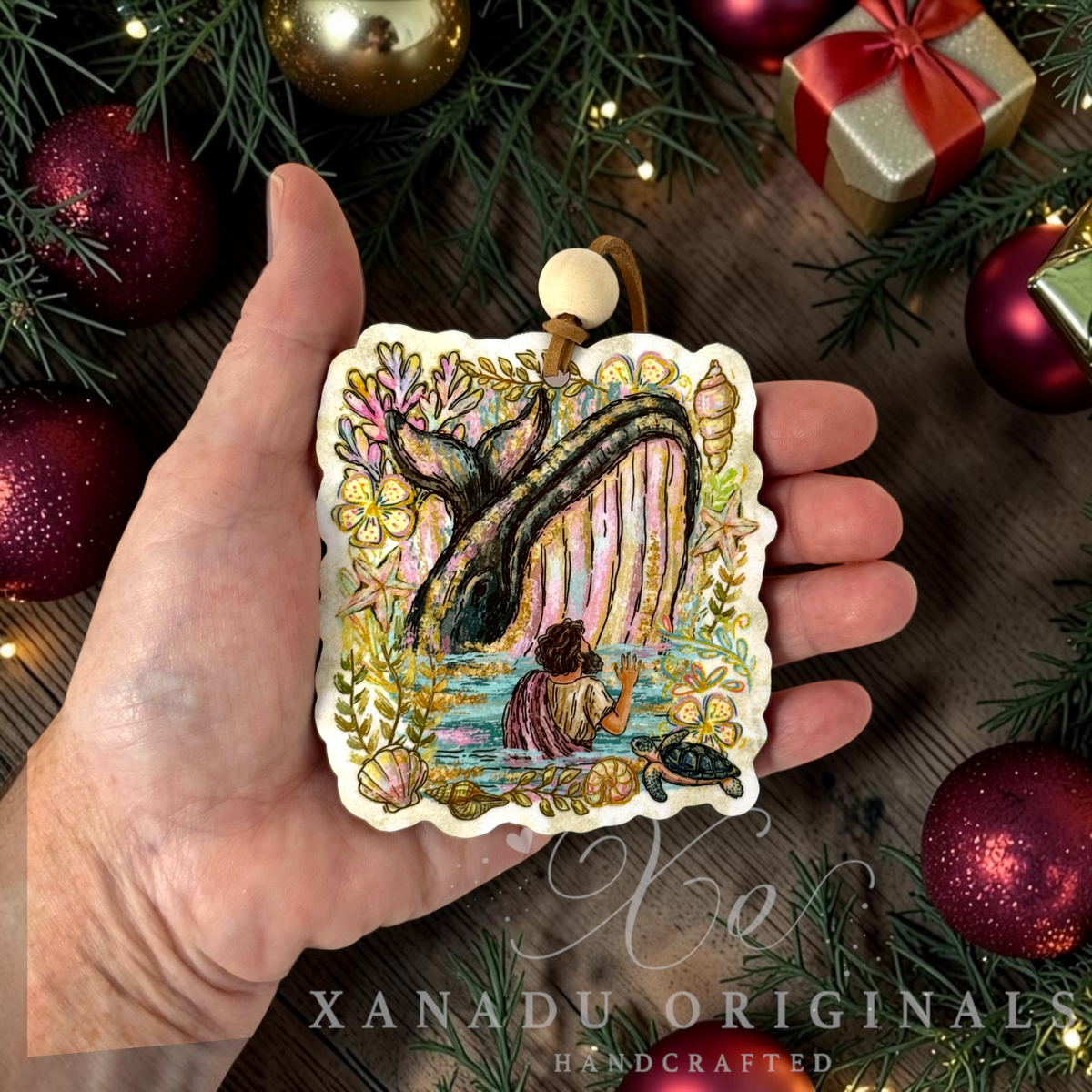 ⢠Retro religious Bible story Christmas ornament measuring 3.24 by 3.55 inches held in a hand next to festive holiday decorations.