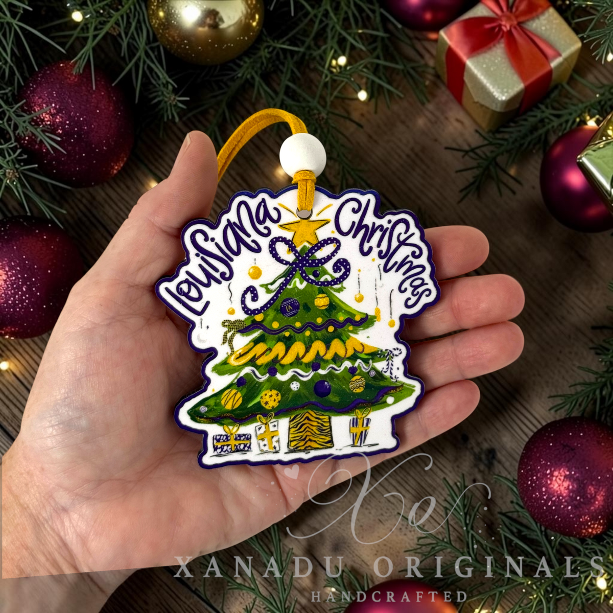 Whimsical Southern collegiate holiday Christmas ornament measuring 3.5 by 3.46 inches held in a hand next to festive decorations.
