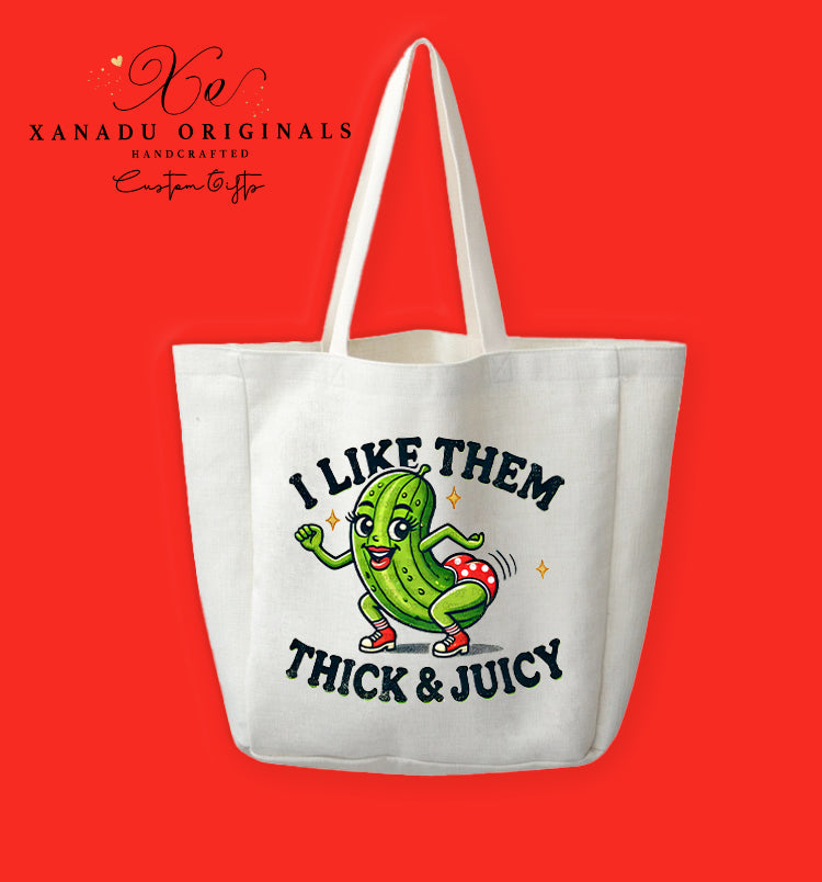 A cream-colored polyester linen tote bag featuring a funny retro cartoon illustration of a dancing pickle in red high heels and shorts next to the text "I LIKE THEM THICK & JUICY".