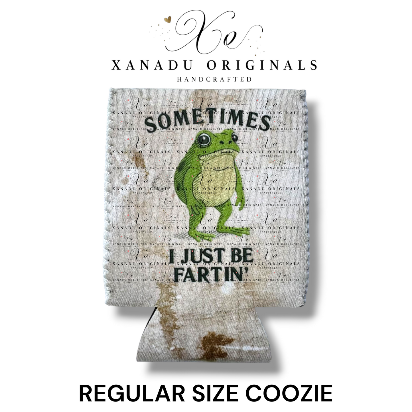 "Xanadu Originals handcrafted regular size neoprene can coozie featuring an illustrated wide-eyed green tree frog with the funny bold text 'SOMETIMES I JUST BE FARTIN'' on a rustic canvas-textured grid background."