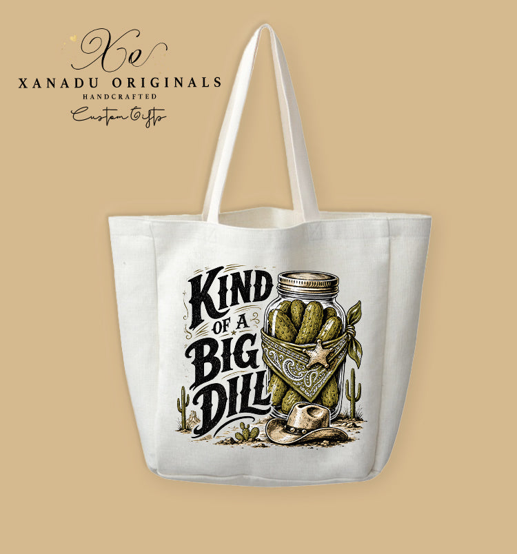 A cream-colored polyester linen tote bag featuring a detailed country western illustration of a mason jar full of pickles wearing a bandana and cowboy hat next to the text "KIND OF A BIG DILL".