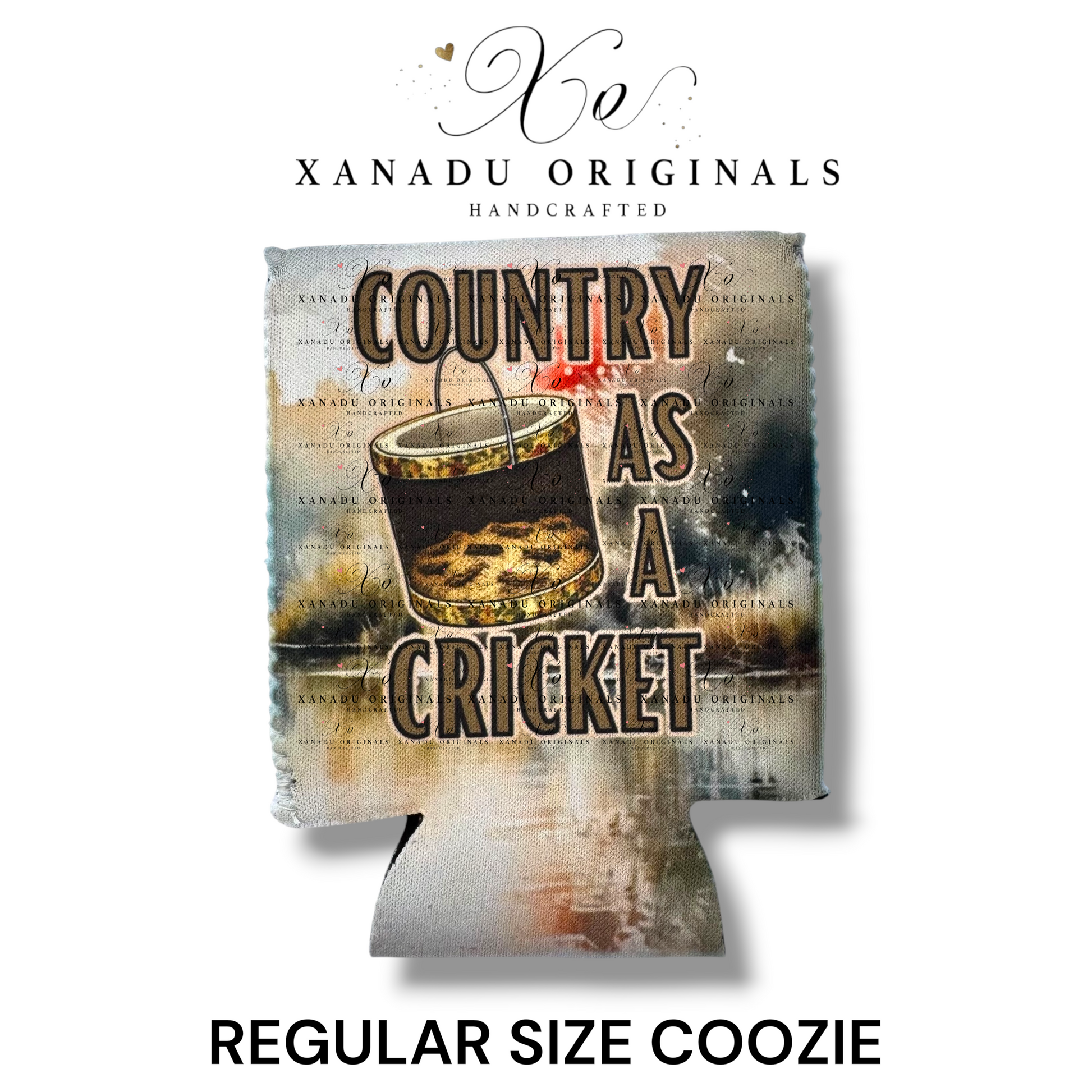 "Xanadu Originals handcrafted regular size neoprene can coozie featuring an artistic illustration of an old bucket filled with crickets with the bold rustic text 'COUNTRY AS A CRICKET' on a distressed canvas background."