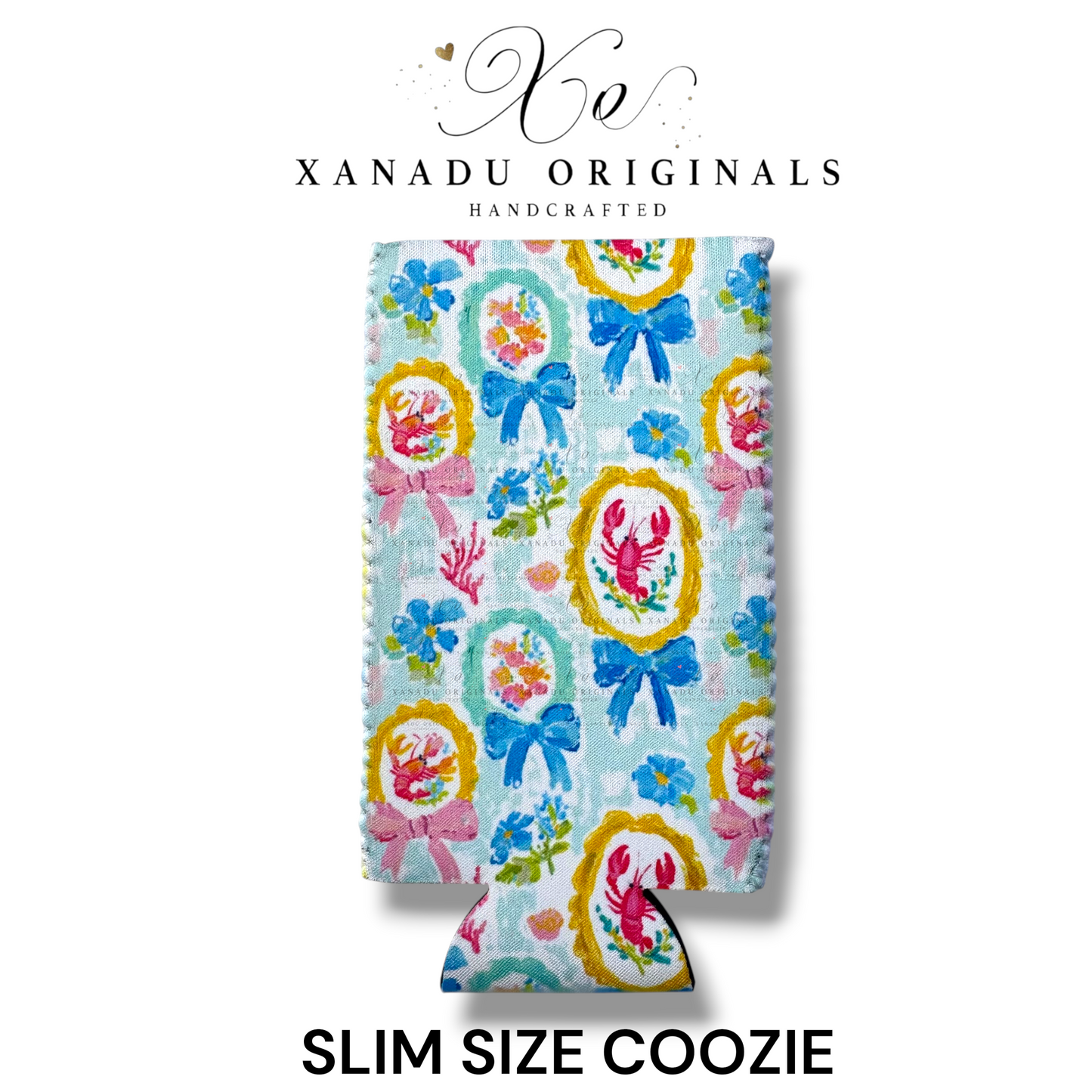 "Xanadu Originals handcrafted slim size neoprene can coozie featuring a vibrant repeating coastal pattern of pink lobsters and crabs crawfish inside ornate gold frames paired with large blue bows over a soft pastel blue background."