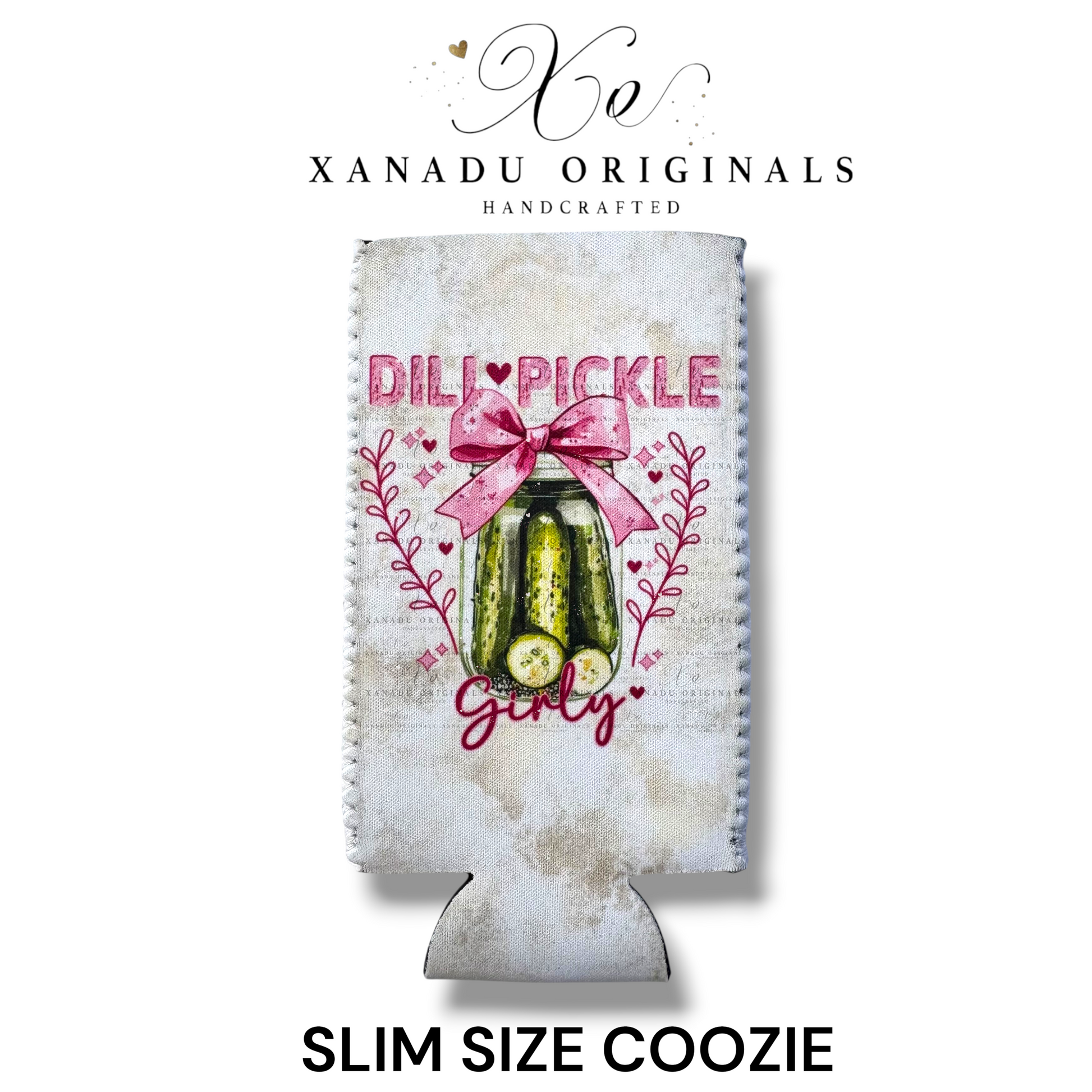 "Xanadu Originals handcrafted slim size neoprene can coozie featuring a rustic glass jar of dill pickles decorated with a large pink bow and the text 'Dill Pickle Girly' against a light textured background."