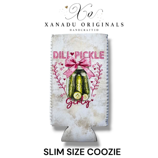 "Xanadu Originals handcrafted slim size neoprene can coozie featuring a rustic glass jar of dill pickles decorated with a large pink bow and the text 'Dill Pickle Girly' against a light textured background."