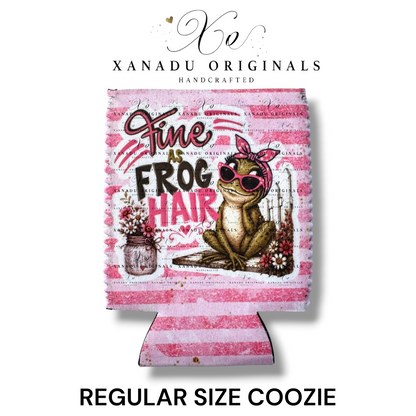 "Xanadu Originals handcrafted regular size neoprene can coozie featuring an illustrated frog wearing a pink bow and sunglasses next to a mason jar of flowers with the southern text 'Fine as Frog Hair' on a pink and white striped background."