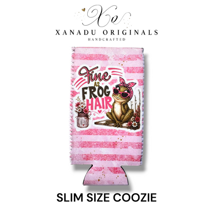 "Xanadu Originals handcrafted slim size neoprene can coozie featuring an illustrated frog wearing a pink bow and sunglasses next to a mason jar of flowers with the southern text 'Fine as Frog Hair' on a pink and white striped background."