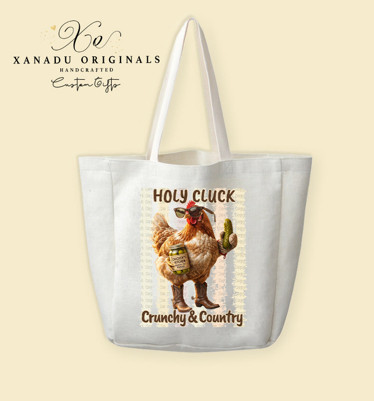 A cream-colored polyester linen tote bag featuring a country western illustration of a cool chicken wearing sunglasses and cowboy boots while holding a jar of pickles next to the text "HOLY CLUCK Crunchy & Country".