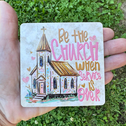 3.6 inch square MDF wood coaster with rounded corners featuring a sketch-style illustration of a white country church chapel with a gold steeple, surrounded by pink and gold hearts, with stylized hand-lettered text reading Be the Church when Service is Over.