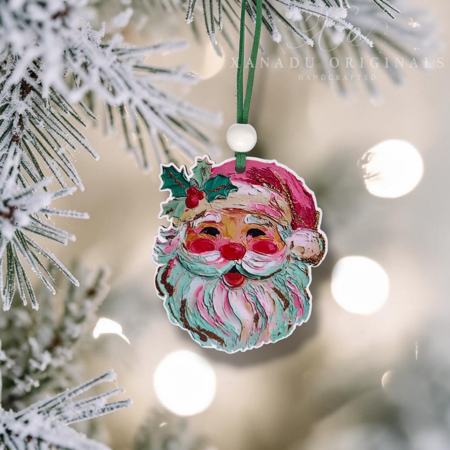 Handcrafted wooden Christmas ornament shaped like Santa's face, hanging from a green string among snowy pine branches with warm bokeh lights in the background.