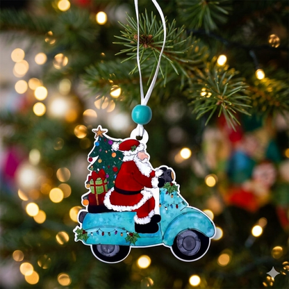 A Christmas ornament shaped like Santa Claus riding a light teal scooter with a small tree on the back, hanging from a white string in front of a blurred Christmas tree with warm lights.