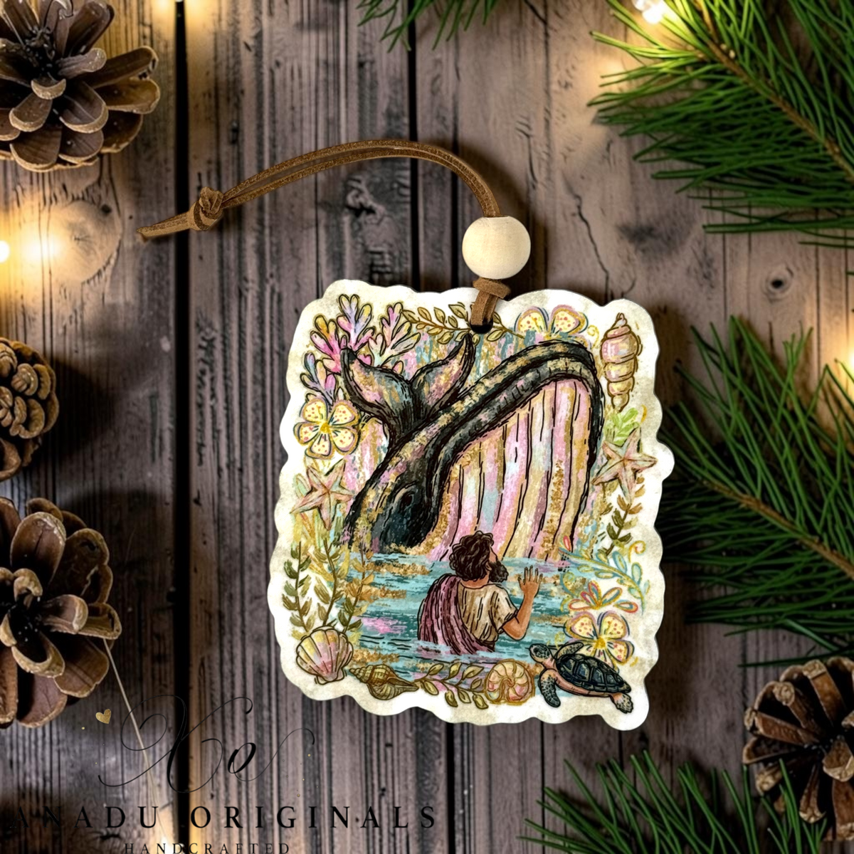 Jonah and the Whale wood ornament featuring a colorful folk art storybook illustration of Jonah looking up at a breaching whale surrounded by coral reef details.