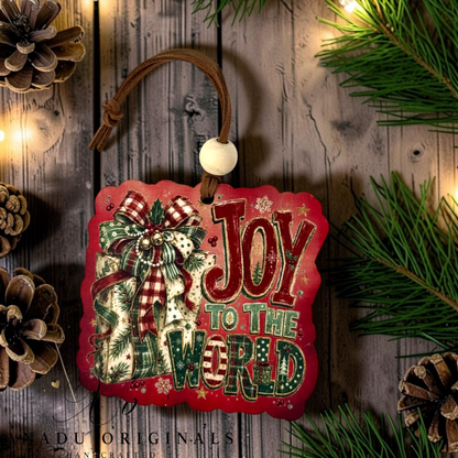 Joy to the World wood ornament featuring a retro holiday present wrapped in evergreen prints with an elaborate plaid gingham bow on a red background.