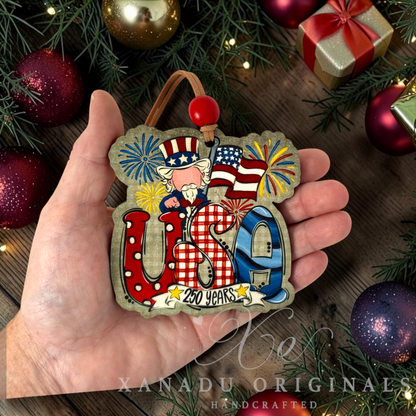 Retro patriotic Uncle Sam 250 Years USA Christmas ornament measuring 3.45 by 3.45 inches held in a hand next to holiday tree decorations.
