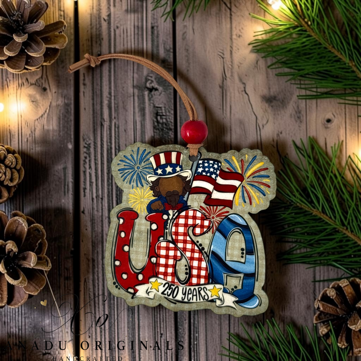 America 250 Years wood ornament featuring Uncle Sam behind patterned USA letters with exploding festive fireworks and a 250 Years scroll banner.