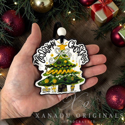 Whimsical Southern collegiate holiday Christmas ornament measuring 3.5 by 3.46 inches held in a hand next to festive decorations.

