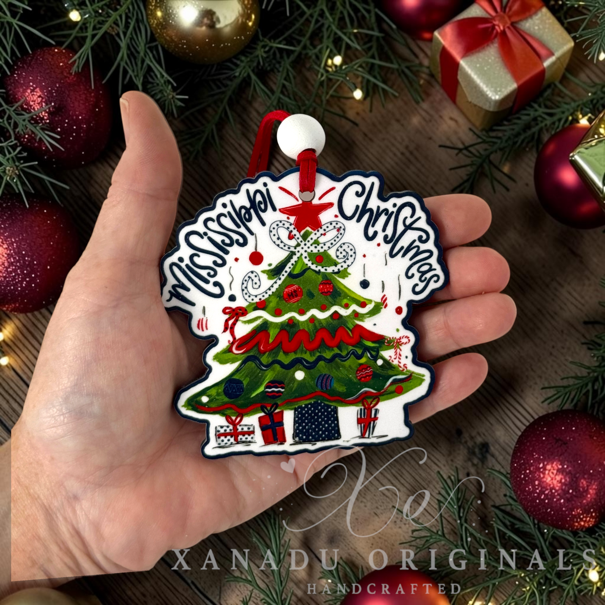 Whimsical Southern collegiate holiday Christmas ornament measuring 3.5 by 3.49 inches held in a hand next to festive decorations.
