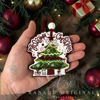 Whimsical Southern state pride holiday Christmas ornament measuring 3.5 by 3.48 inches held in a hand next to festive decorations.