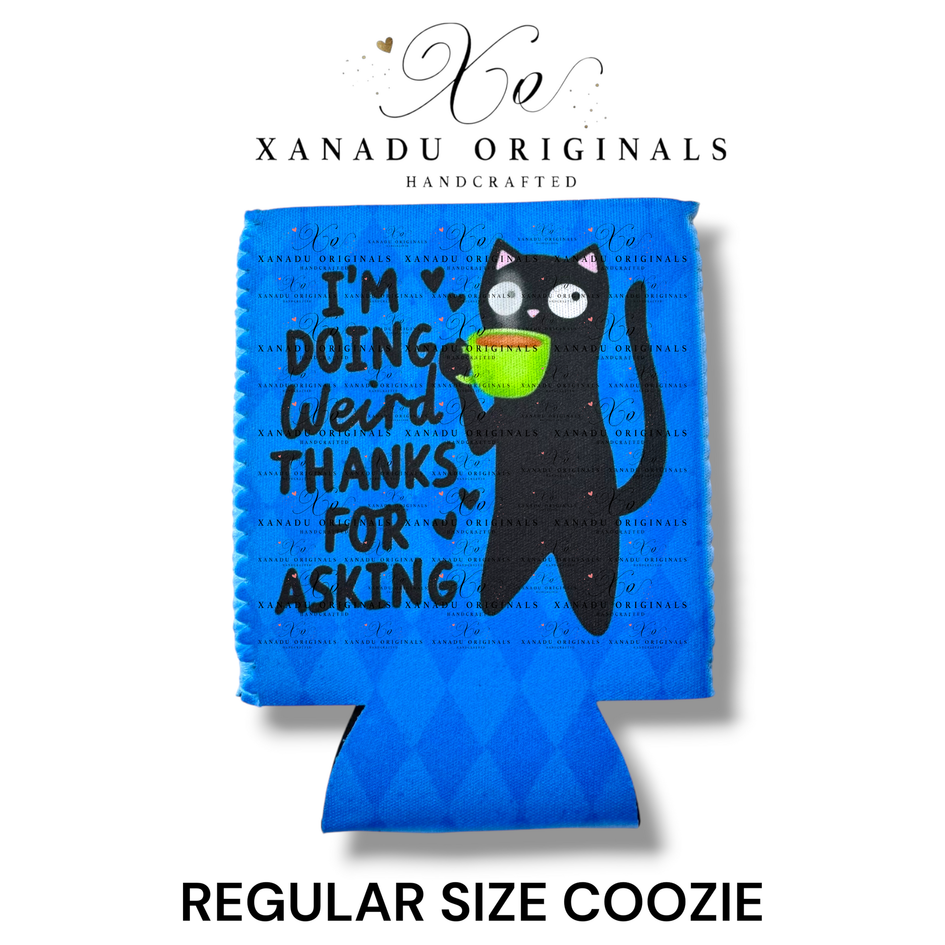 "Xanadu Originals handcrafted regular size neoprene can coozie featuring an illustrated wide-eyed black cat holding a green coffee cup with the funny text 'I'M DOING WEIRD THANKS FOR ASKING' on a vibrant royal blue textured background."