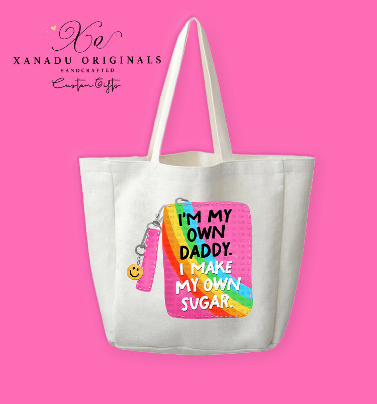 A cream-colored polyester linen tote bag featuring a cartoon illustration of a hot pink and rainbow striped zippered wristlet wallet with a smiley face keychain. Bold black and white text on the wallet reads "I'M MY OWN DADDY. I MAKE MY OWN SUGAR."