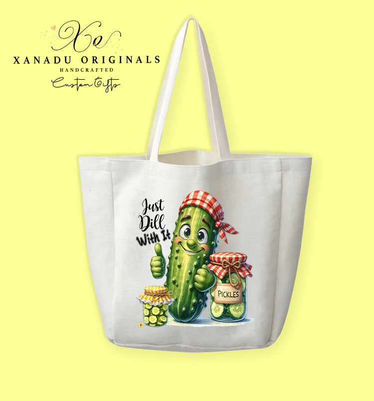 A cream-colored polyester linen tote bag featuring a cute cartoon illustration of a smiling pickle character giving a thumbs up next to pickle jars under the text "Just Dill With It".