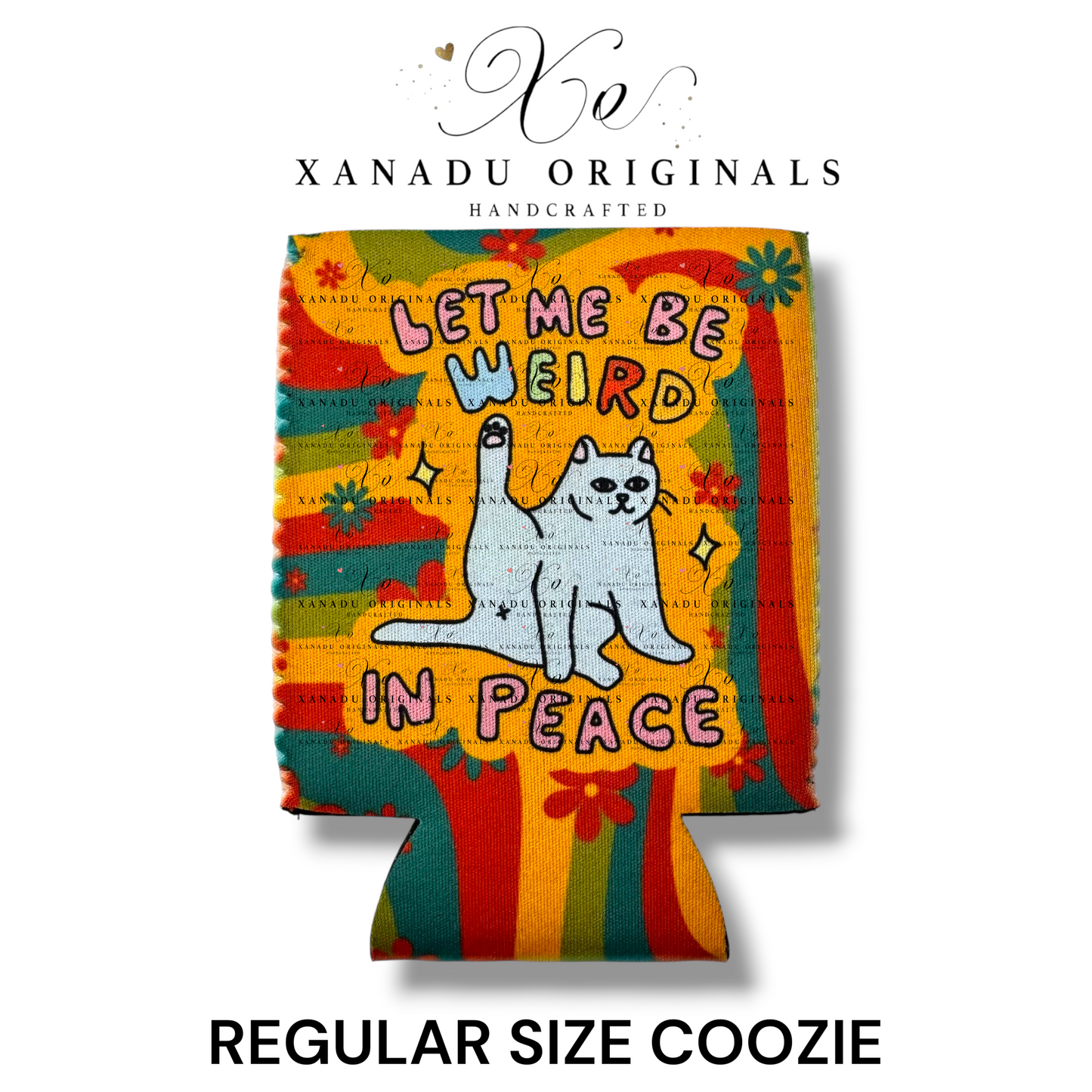 "Xanadu Originals handcrafted regular size neoprene can coozie featuring an illustration of a white cat stretching its leg in the air with the funny quote 'LET ME BE WEIRD IN PEACE' over a groovy, melting 1970s retro rainbow and floral background."