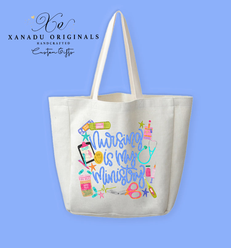 A cream-colored polyester linen tote bag featuring a collage of colorful medical doodles including a teal stethoscope, bandages, a clipboard, medical scissors, and medication bottles surrounding stylized blue script text that reads "Nursing is my Ministry."