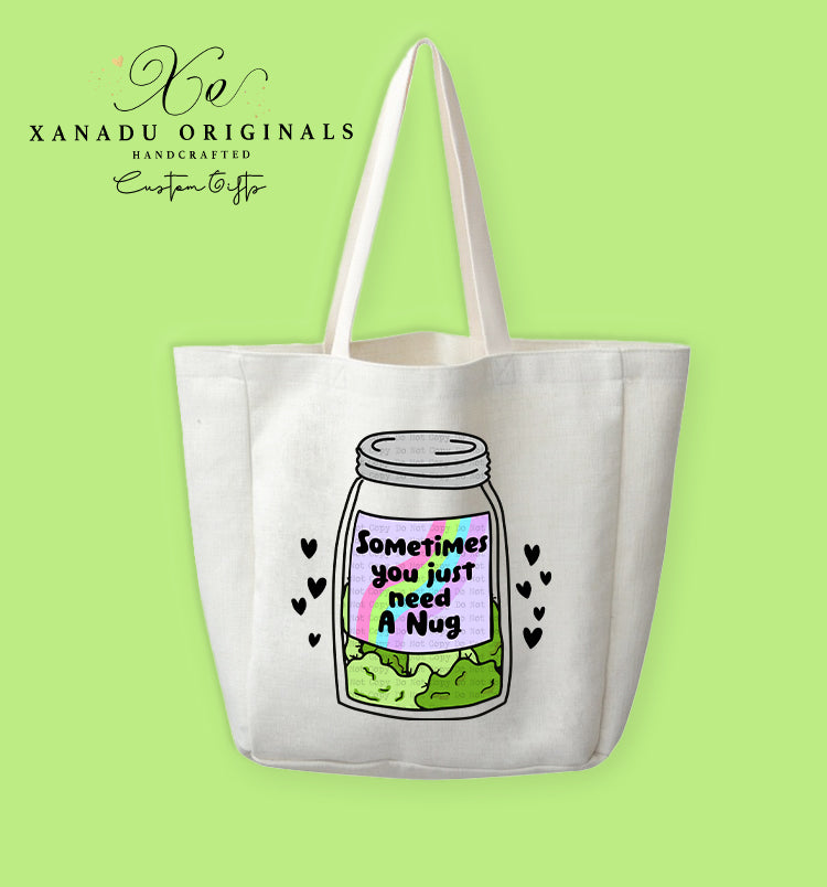 A cream-colored polyester linen tote bag featuring a cartoon illustration of a clear glass mason jar filled with green cannabis flower nugs. The jar has a label with a retro rainbow border and bold black text that reads "Sometimes you just need A Nug," surrounded by tiny floating black hearts.