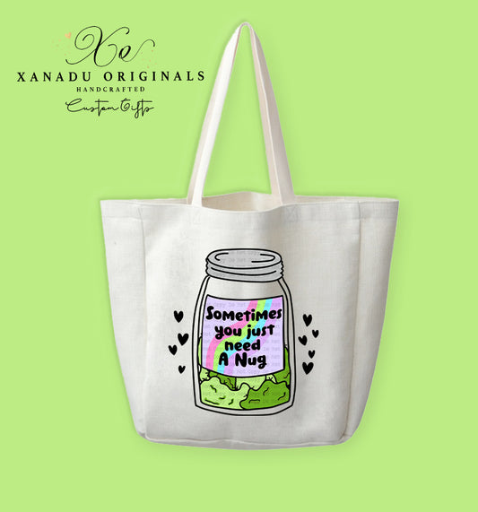 A cream-colored polyester linen tote bag featuring a cartoon illustration of a clear glass mason jar filled with green cannabis flower nugs. The jar has a label with a retro rainbow border and bold black text that reads "Sometimes you just need A Nug," surrounded by tiny floating black hearts.