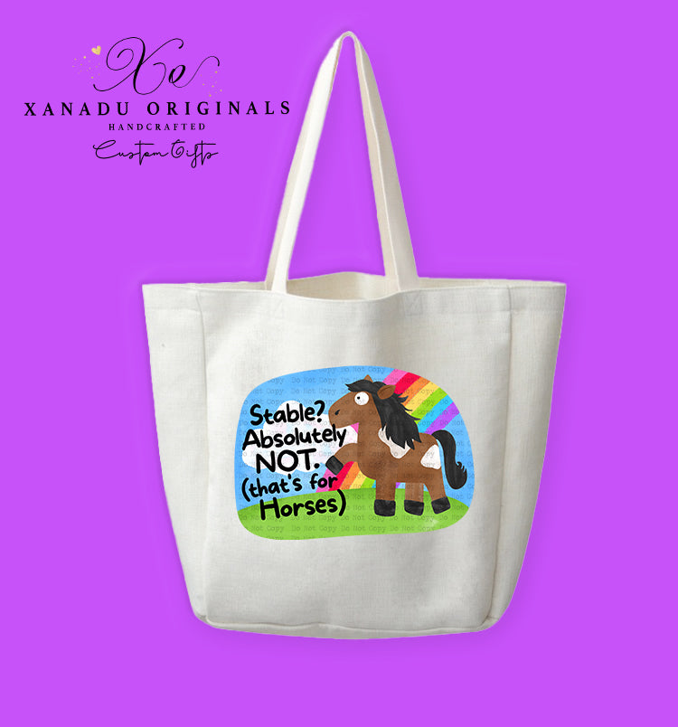 A cream-colored polyester linen tote bag featuring a cartoon illustration of a wide-eyed brown horse with white patches standing on a green hill under a blue sky with a retro rainbow. Bold black text to the left reads "Stable? Absolutely NOT. (that's for horses)".