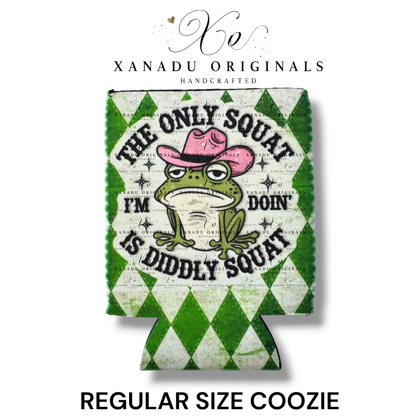 "Xanadu Originals handcrafted regular size neoprene can coozie featuring an illustrated grumpy green frog wearing a pink cowboy hat with the funny bold text 'THE ONLY SQUAT I'M DOIN' IS DIDDLY SQUAT' on a green and white diamond argyle background."