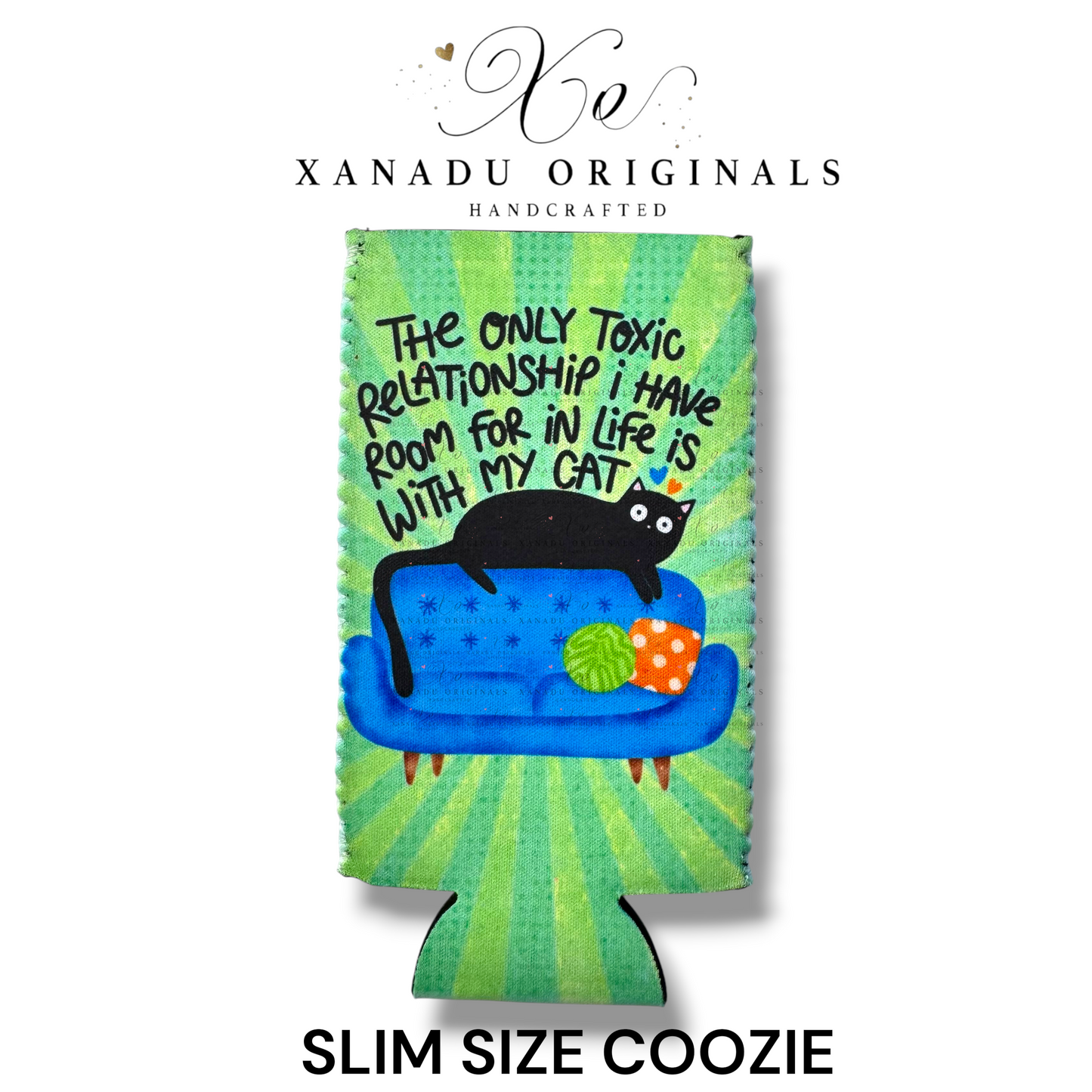 "Xanadu Originals handcrafted slim size neoprene can coozie featuring a black cat laying on a blue couch with the funny quote 'The only toxic relationship I have room for in life is with my cat' on a vibrant green starburst background."