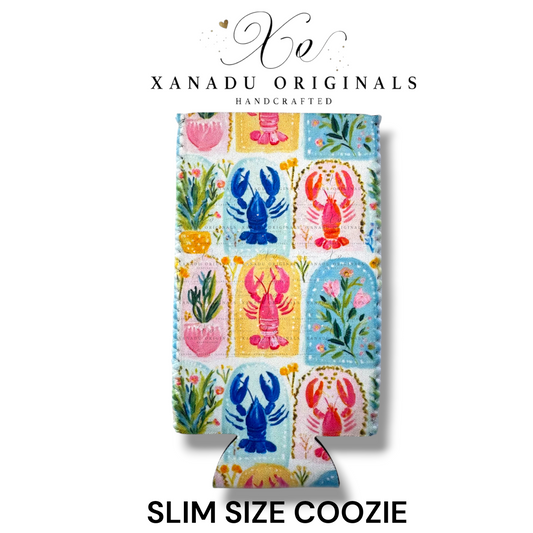 "Xanadu Originals handcrafted slim size neoprene can coozie featuring a vibrant watercolor mosaic pattern of royal blue, coral pink, and red lobsters paired with green sea kelp and flowers against a light textured background."