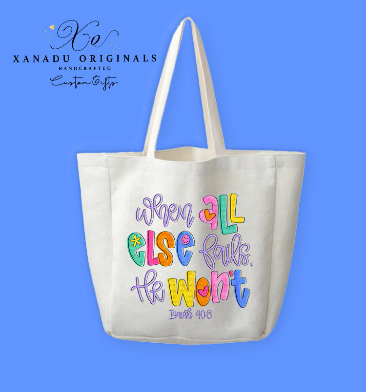 A cream-colored polyester linen tote bag featuring stylized, multi-colored retro bubble lettering in vibrant pink, blue, green, purple, and yellow. The text reads "when ALL ELSE fails, He Won't" with a tiny smiley face, hearts, a flower, and "Isaiah 40:8" written below.